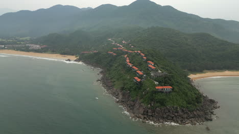 Vietnam-Mountain-Range-Extends-Into-Chan-May-Bay-With-Idyllic-Holiday-Villas-Scattered-On-Top