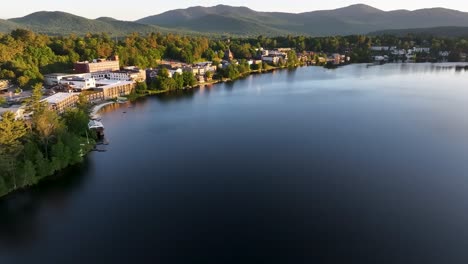 Flying-along-the-shore-of-Mirror-Lake-in-Lake-Placid,-New-York