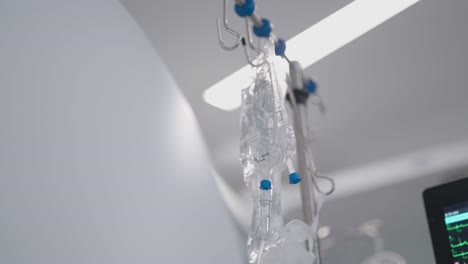 Low-angle-view-of-saline-bags-being-uses-during-surgery-at-cardiology-department-in-French-hospital