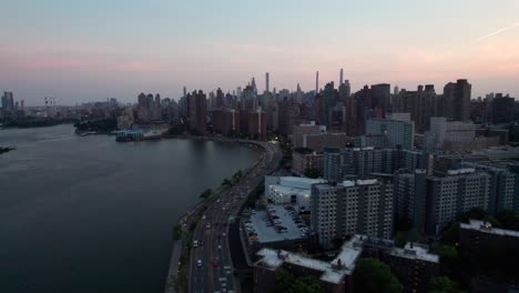 New-York-City's-East-River-and-FDR-drive-at-night,-drone-shot,-4K