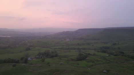 A-view-of-the-valley-drowned-in-the-pink-mist-of-sunset-clouds-floating-above-the-hills
