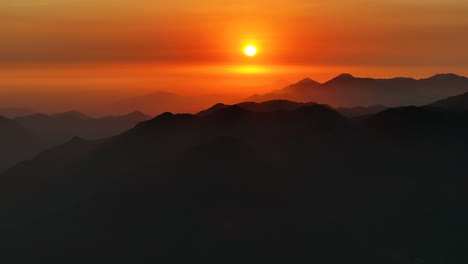 Left-Aerial-Drone-Panning-Orange-Sunset-Golden-Hour-Cut-Out-Mountains-Haze-Cloud-Contrasted-Lima-Peru