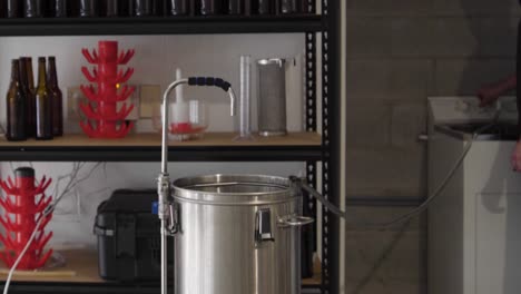 Filling-a-metal-brewing-kettle-with-water-from-a-hose-in-a-home-craft-brewery