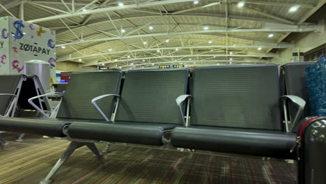 Spacious-waiting-area-at-Larnaka-Airport-in-Cyprus-with-empty-seats-and-vibrant-decor