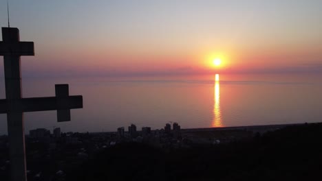 Cross-with-a-sunset-background,-Gonio-Georgia,-Black-Sea,-beautiful-sunset-over-the-sea