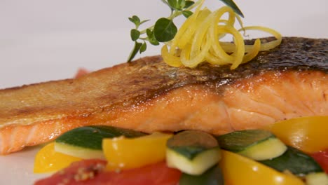 Close-up-of-a-beautifully-plated-salmon-with-crispy-skin-and-fresh-vegetables