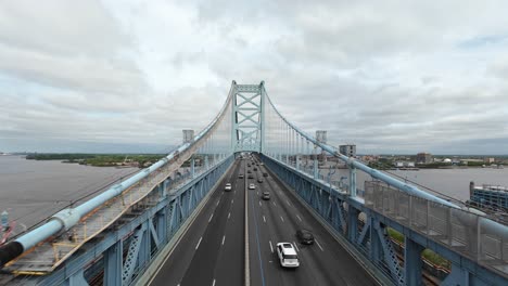 Busy-Traffic-scene-on-famous-Benjamin-Franklin-Bridge-in-Philadelphia-crossing-Delaware-River