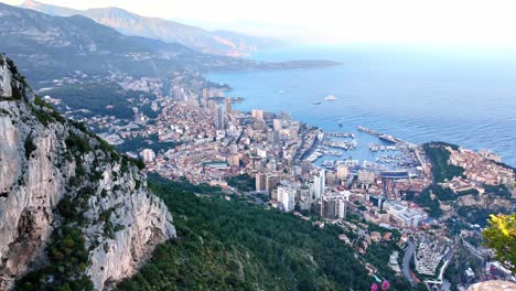 The-Principality-of-Monaco-looking-towards-Port-Hercule,-viewed-from-a-scenic-overlook-in-France-from-the-mountains