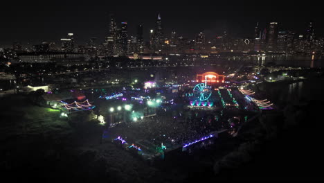 Drone-circling-the-Beyond-Wonderland-Festival,-night-in-Northerly-Island,-Chicago