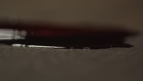 Beautiful-macro-close-up-of-a-puddle-of-blood-on-a-floor-with-a-sharp-knife-lying-in-the-pool-of-blood