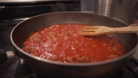 Red-spaghetti-sauce-boiling-in-a-Teflon-kitchen-pan-on-a-stove