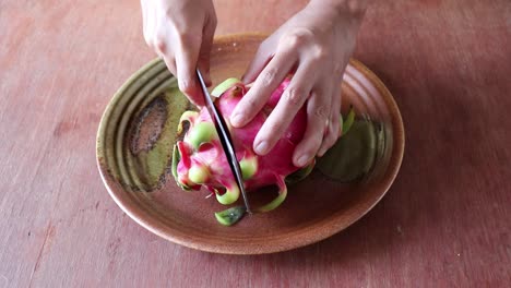 Peeling-and-slicing-a-red-dragon-fruit-or-pitaya