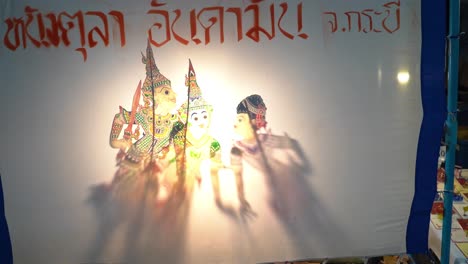 Traditional-Asian-shadow-puppetry-on-village-street-in-Thailand,-Nang-Yai
