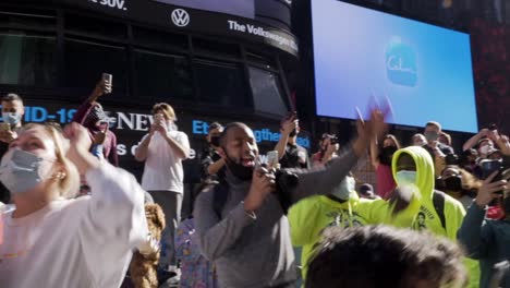 A-crowd-of-Biden-Harris-supporters-in-Times-Square-dance-and-sing-to-celebrate-the-results-of-the-2020-US-Presidential-Election