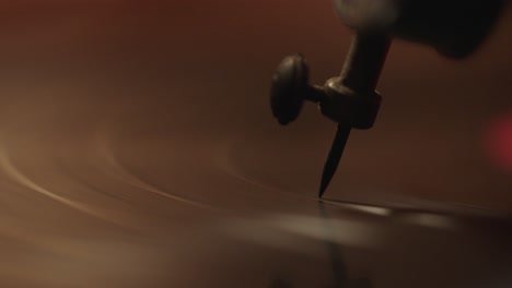 Close-up-of-a-needle-and-vinyl-record-revolving-on-a-vintage-record-player