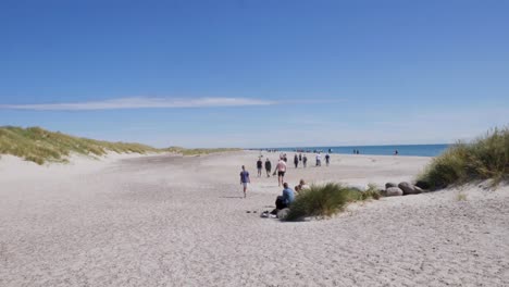 People-and-Families-Walking-On-The-Popular-Beach-in-Skagen-at-Summer,-Handheld-Wide-Shot