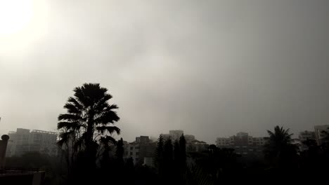 Timelapse-of-fog-during-winter-weather-just-after-sunrise-with-blue-sky-above-while-city-is-overcast-by-fog---coronavirus