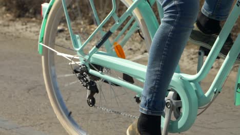 Back-wheel-spinning-of-a-turquoise-bicycle