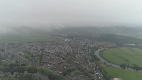 High-aerial-shot-revealing-Stirling-and-the-River-Forth-with-the-Wallace-Monument-in-the-distance-on-a-low-lying-cloud-day
