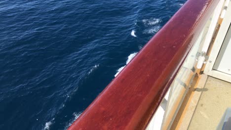 Ship-wooden-rail-with-out-of-focus-waves-and-wake-below