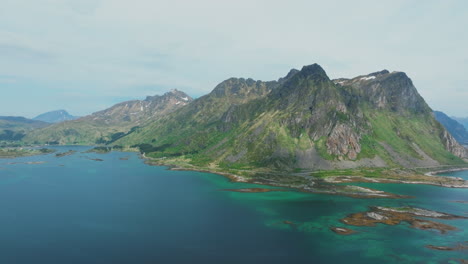 Aerial-view-in-orbit-over-large-mountains,-lakes-and-islets-of-the-municipality-of-Vestvagoy-in-the-Lofoten-Islands