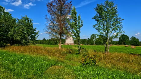 Ancient-Stone-Windmill-In-A-Rural-Farmland-During-Harvest-Season