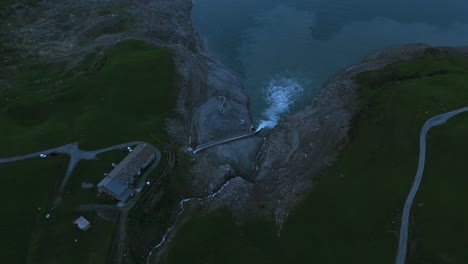 Bird's-eye-aerial-view-of-water-from-spillway-entering-reservoir-Lake-Mont-Cenis